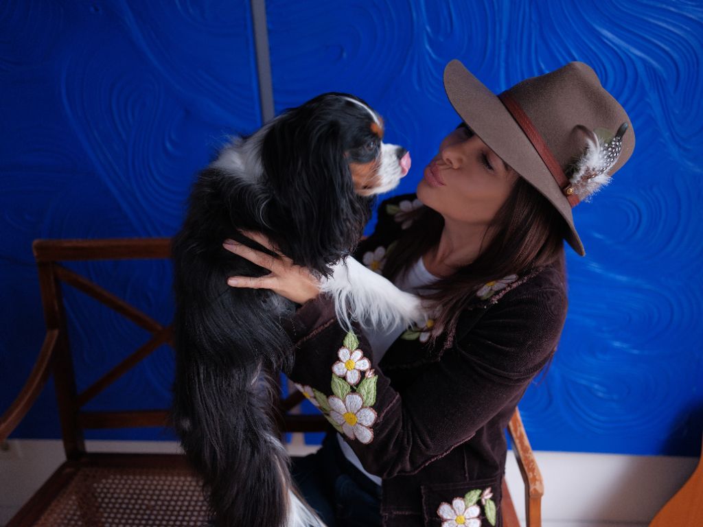 The Well Canine founder holding her Cavalier King Charles Spaniel
